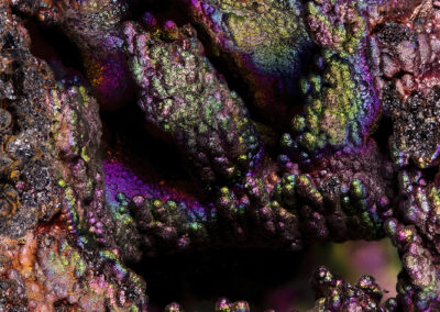 Iridescent nodules on a dark background