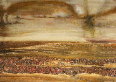 A landscape-like mineral cross section with a wispy pale yellow sky