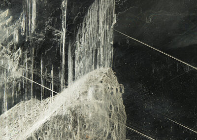 White threadlike structures and a white waterfall with a black background