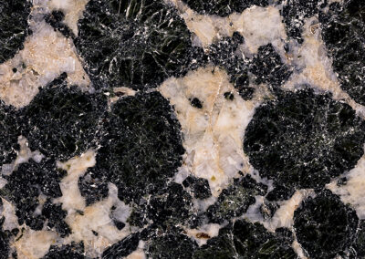 White and pale yellow crystals with orblike black intrusions