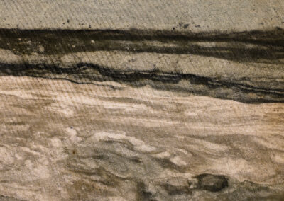 Swirling tan and gray riverlike mineral formations