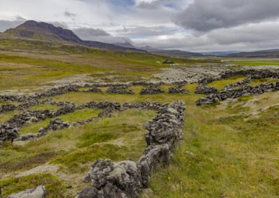Icelandic valley with ruined stone walls in foreground