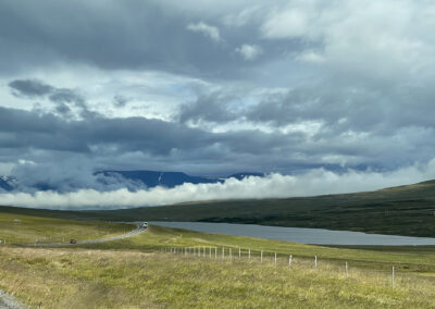 A road in Iceland with foggy hills in the background