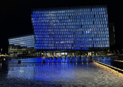 A night view of the Harpa Concert Hall with crystalline blue highlights