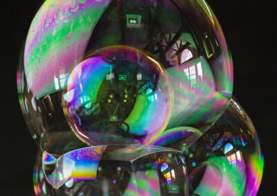 A congeries of iridescent bubbles form patterns and reflections