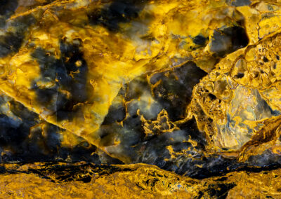 Bright yellowish patterns in a mineral formation