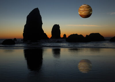 Photo composition of a Jupiter-like orb in the sky over jutting rocks on a sunset seashore