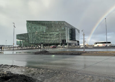 A rainbow near a modernist Icelandic building