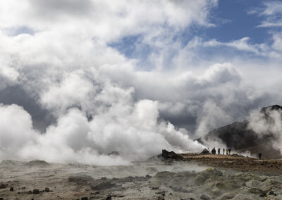 Volcanic plumes rise from a rocky scene in Iceland