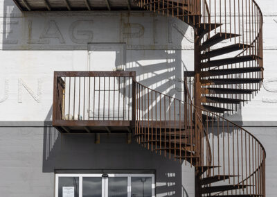 A spiral fire escape creates shadows on an Icelandic building