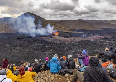 Spectators watch a volcanic field in Iceland