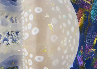 A half-spherical jellyfish overlaid with an iridescent mineral texture