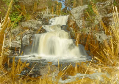 A waterfall amid golden crystalline structures