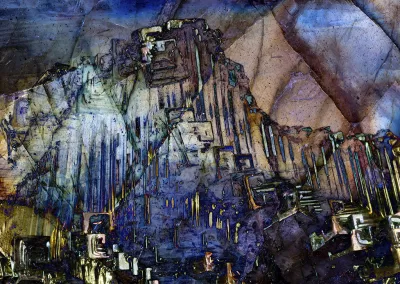 A giant crystalline figure rises in a mineral background