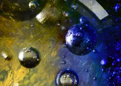 Bubbles within a dendritic yellow and blue mineral background